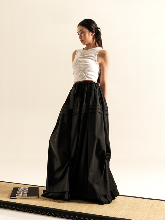 LONG SKIRT WITH SIDE DRAPING AND PLATED RUFFLE HEM