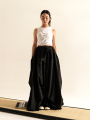 LONG SKIRT WITH SIDE DRAPING AND PLATED RUFFLE HEM