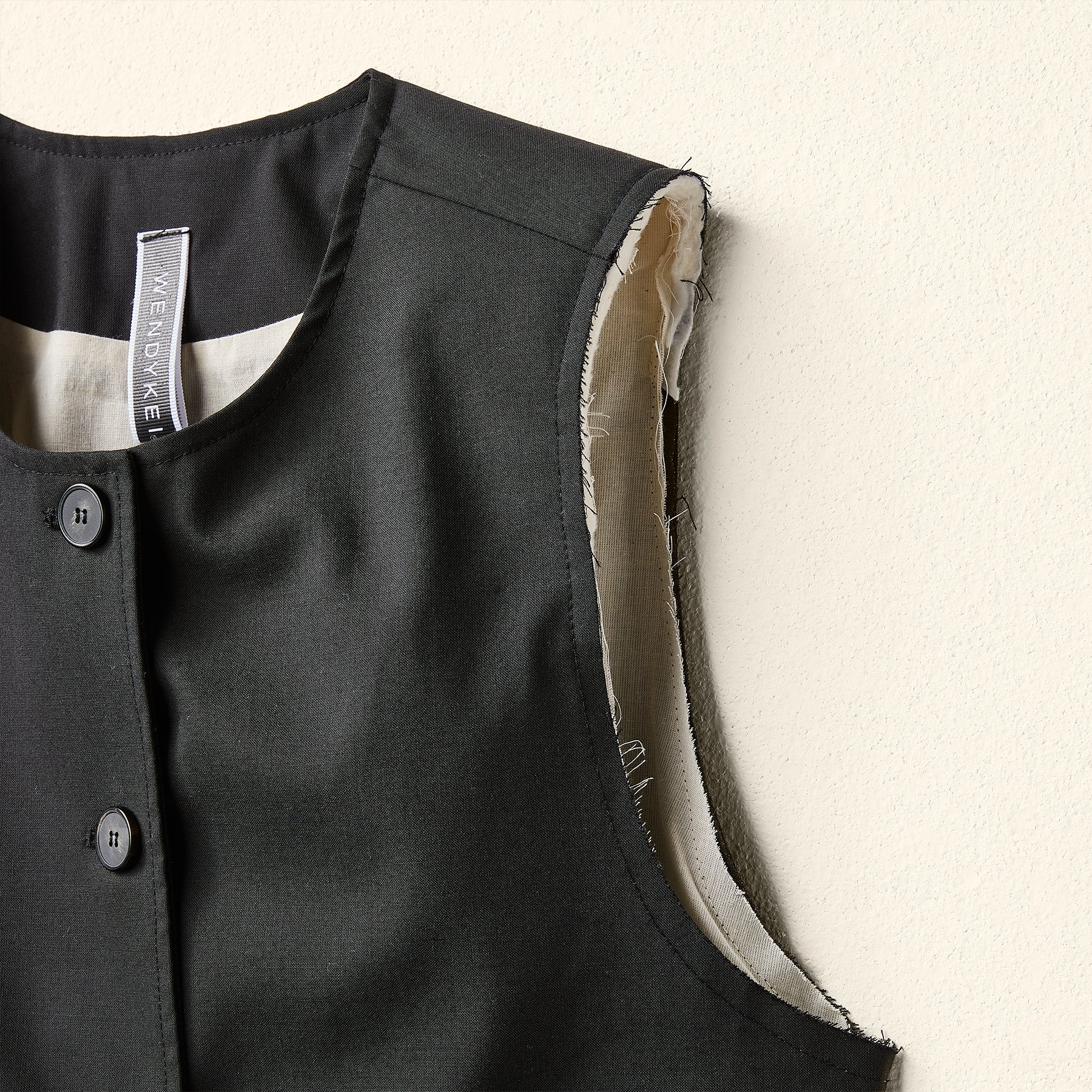 VEST DOUBLED IN ECRU' FABRIC WITH PADDED SHOULDERS AND BUTTONS